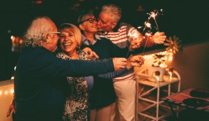 Older friends with dental implants celebrating NYE