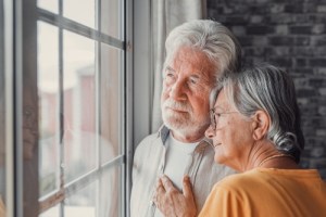 Couple looking out window together